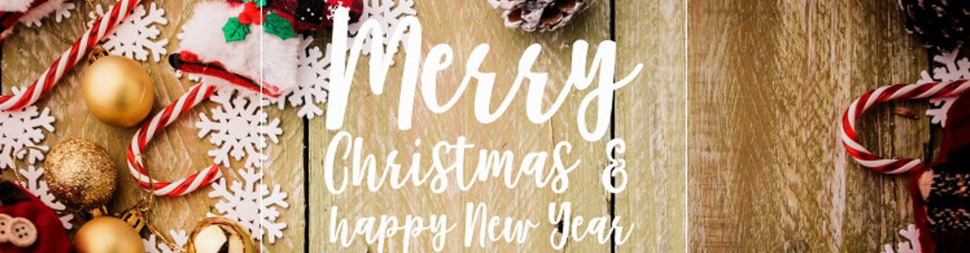 festive background concept with christmas decorating items on wooden background with light filter